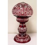 Ruby flashed cut glass table lamp the globular shade on baluster column, 35cm high.