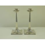 Pair of silver table candlesticks of Arts and Crafts style,