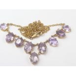 Necklace of Victorian style with nine oval amethysts in gold.