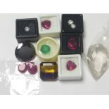Two heat treated cabochon rubies, a banded amethyst / citrine and various other unmounted gems.