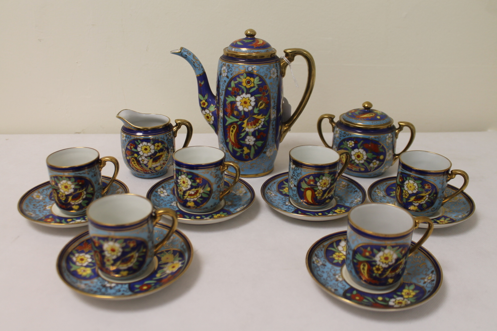 Noritake floral decorated coffee set in polychrome and gilt for six settings.