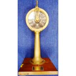 Miniature brass ship's telegraph. Made by Chadburn's Liverpool & London. Mounted on wooden plinth.