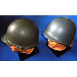 Two American army helmets with modern inserts.