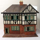 Early 20th century Tudor style dolls house and a small quantity of dolls house furniture etc