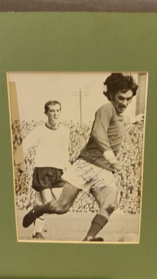 FOOTBALL, signed magazine photo by George Best, full-length in action for Northern Ireland,