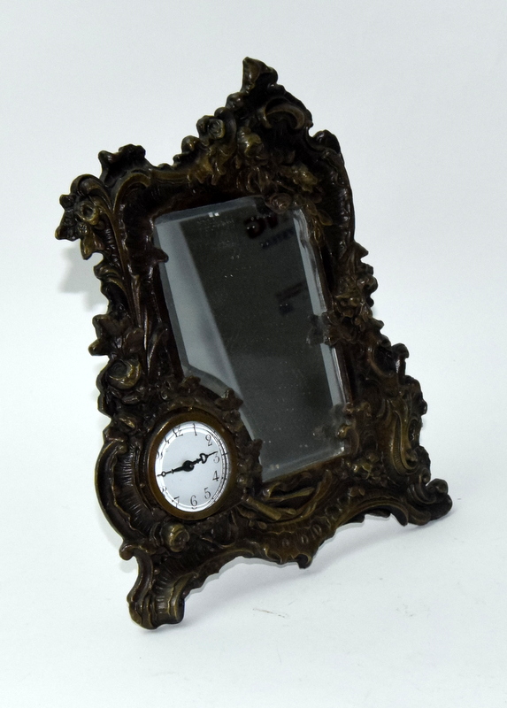 An Art Deco style bronze easel back mirror with clock