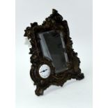 An Art Deco style bronze easel back mirror with clock