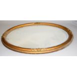 An oval gilt framed beveled edged mirror