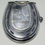 a silver plated vesta case in the shape of a horseshoe