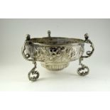 A silver bowl on 3 feet