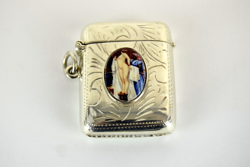 a silver vesta case with nude enamel image