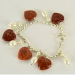 a silver freshwater pearl and heart shaped apple coral bracelet