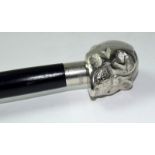 A silver plated ebonized walking cane with skull handle