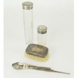 Silver brush ,two silver topped bottles a silver handled button pull