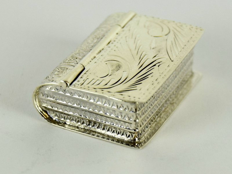a 925 silver pill box in the form of a book