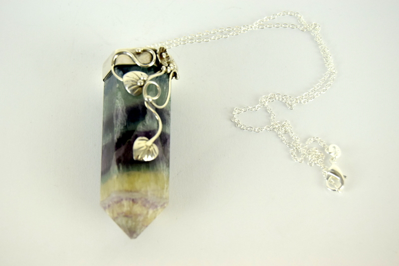 a substantial amethyst and crystal pendant necklace with silver fittings