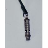 A whistle marked The City Police or Fire Whistle Patent. On its cord lanyard. No makers name