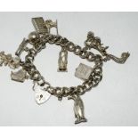 Ladies silver charm bracelet with 11+good charms