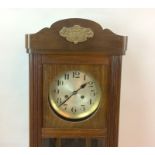 Mahogany wall clock brass face with key and pendulum