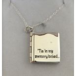 an unusual silver locket in the form of a book on silver chain