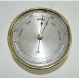 A silvered dial wall barometer. 12cm diameter