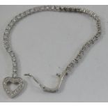 a silver and cz bracelet with heart shaped clasp