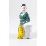 a ceramic perfume bottle in the form of a Chinese figure