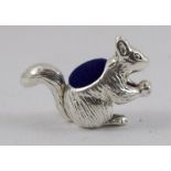 a silver squirrel pin cushion