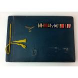 A WW2 Third Reich Luftwaffe Pilots personal photograph album and his mounted medal ribbon bar with