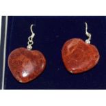 a pair of silver and apple coral heart shaped earrings cased