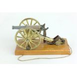 An unusual Breach Loading fully working desk top model cannon secured to a wooden base. Barrell