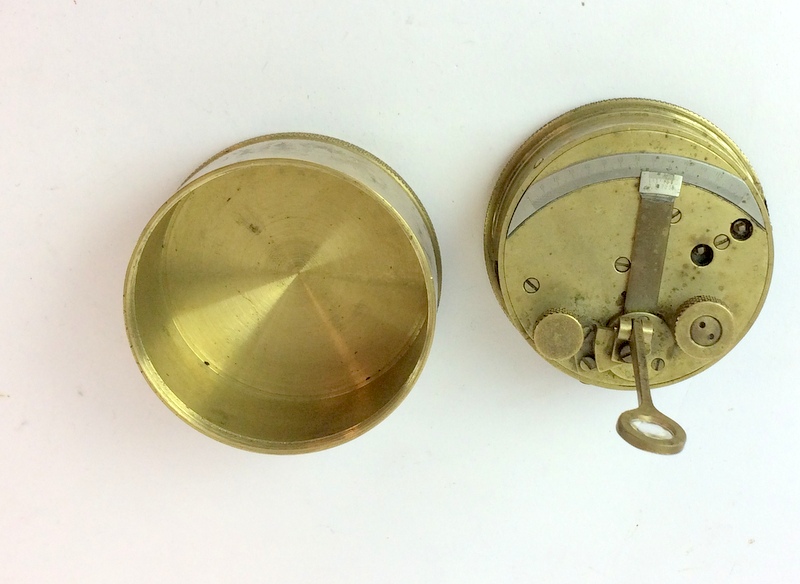 A brass cased Clinometer 8cms diameter with impressed serial number 4058