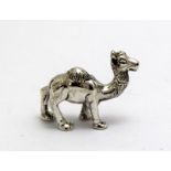 a silver figure of a camel