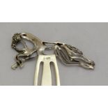 a large silver bookmark with horse finial