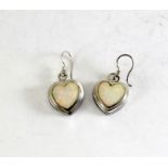 a pair of silver and opal heart shaped earrings