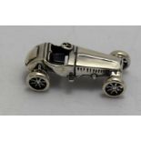 a cast silver figure of a vintage car