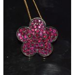 an 18 ct yellow gold ruby pendant necklace in the form of a lucky five leaf clover