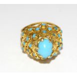 An Oriental yellow metal turquoise ring. Size K