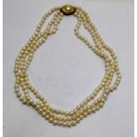 a yellow gold diamond set three row cultured pearl necklace