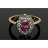 an 18ct yellow gold ruby and diamond daisy style ring