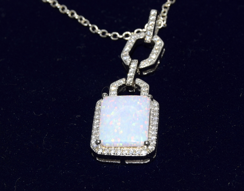 a silver and rectangular opal pendant necklace on silver chain