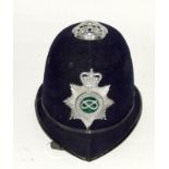 An obsolete Staffordshire Police helmet with badge. Retains its chin strap and liner