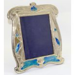 a large silver plated and enamel easel back picture frame