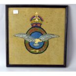 A framed and glazed WW2 wool work embroidery of the Royal Air Force badge. Overall size 29cms x