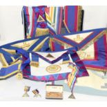 A Briefcase of Masonic Regalia, including sashes, aprons, medals and jewels.