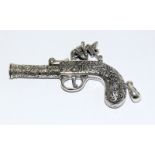 an unusual silver whistle in the form of a percushion gun