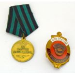 A Russian 1945 Medal for the Capture of Koenigsberg with a Russian gilt and enamel military badge