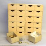 A collection of miniature drawers with an assortment of reproduction brass handles