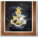 An impressive WW1 oak framed and glazed wool work embroidery of the badge of the 12th County of