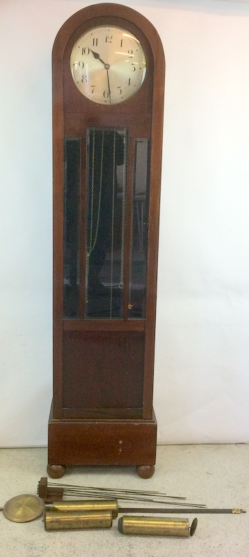 Round head grandmother striking clock in a mahogany case with weights and mechanism